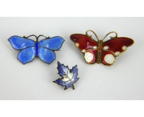 A David Anderson enamelled silver butterfly brooch, a similar silver butterfly brooch and an enamel leaf brooch. Largest 3.6c