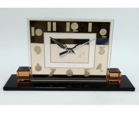 A 1930s Art Deco mirrored glass mantel clock with pink tinted glass dial on a black glass plinth. Height 21.5cm, width 40cm