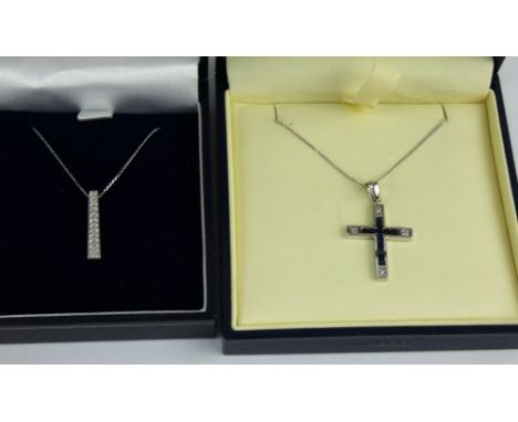 A 9ct white gold and sapphire crucifix and chain, &amp; a similar diamond set pendant and chain. Both chains 45cm. Combined g