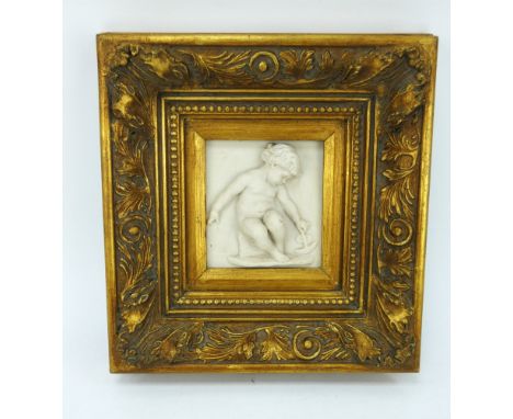 A rococo style parian ware plaque of a putti playing with a boat, mounted in a deep gilt frame. Overall size 34cm x 36cm