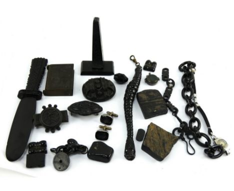 A mixed collection of jet and vulcanite including brooches, paper knife, watch chain, vesta etc