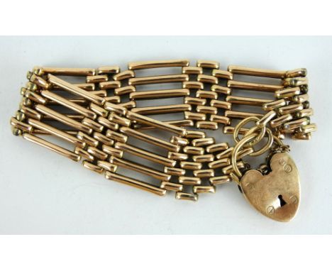 A gold gate bracelet with heart shaped padlock clasp and safety chain. Marked 9ct. Length 17cm. Gross weight 26 grams.