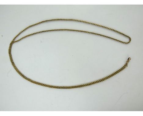 An antique yellow metal fancy link long spectacle chain with dog clip. Unmarked. Length: 130cm. Gross weight 24 grams.