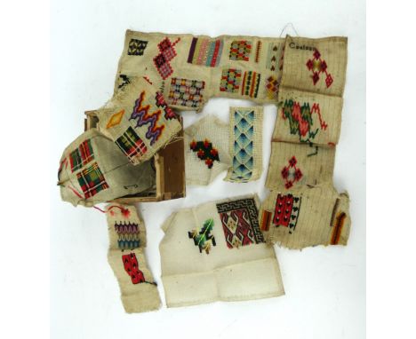 A collection of antique tapestry sample patterns in vibrant colours, many marked Coulson