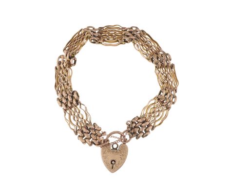 An early 20th century 9ct gold gate bracelet, with floral engraved heart-shape padlock clasp and safety chain, clasp stamped 