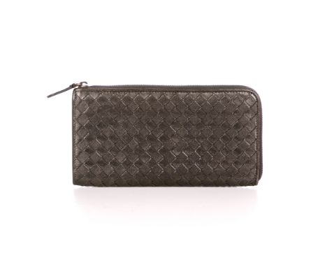Bottega Veneta, an Intrecciato Zippy wallet, designed with the maker's signature woven intrecciato brown leather exterior, wi
