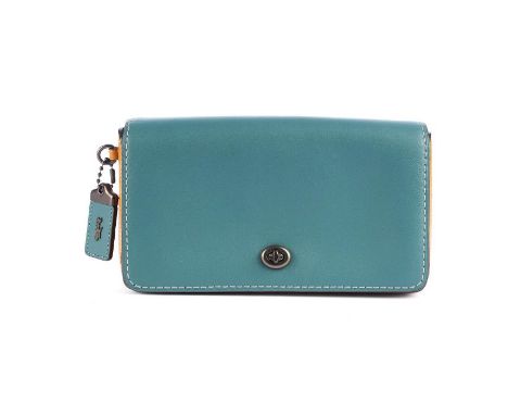 Coach, a Dinky crossbody handbag, featuring a turquoise and mustard glovetanned leather exterior, with a detachable chain and