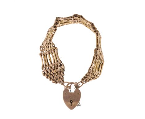 An early 20th century 9ct gold gate bracelet, with heart-shape padlock clasp and safety chain, stamped 9c, length 19cm, total