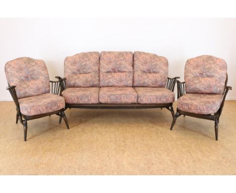 Brown wooden 3-seater sofa, and 2 chairs, with cushions with  floral fabric, designer: Luigi Ercolani, for: Ercol Furniture, 