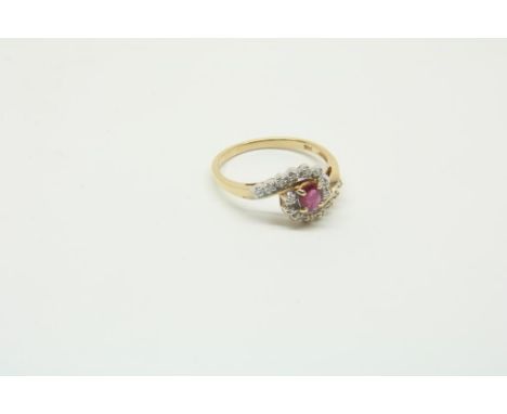 Yellow gold ring set with ruby and diamonds set in white gold,  585/000, gross w. 3 gr., seize 18.Geelgouden slagring bezet m