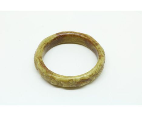 Jadeiet bangle with fishes, diam. 7 cm.Handgesneden jadeiet armband met vissen, diam. 7 cm.