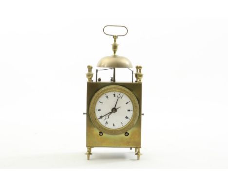 Travel alarm clock, so-called capucine in brass case, at 4 cast  legs, crowned with 4 decorative buttons, bell and handle,  r