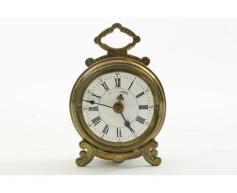 A French brass alarm clock with enamel dial and decorated legs  and handle, ca. 1900.Messing wekker met emaille wijzerplaat e