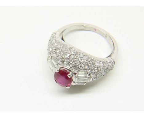 White gold entourage ring set with ruby approx. 1. ct. and 6 baguette cut diamonds and 84 brilliant cut diamonds. Of report f