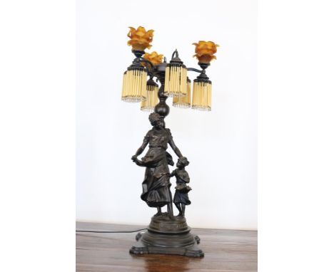 Zamak 8-light table lamp with figures and yellow glass shades  with beads, h. 90 cm.Zamak 8 lichts tafellamp met figuren en g