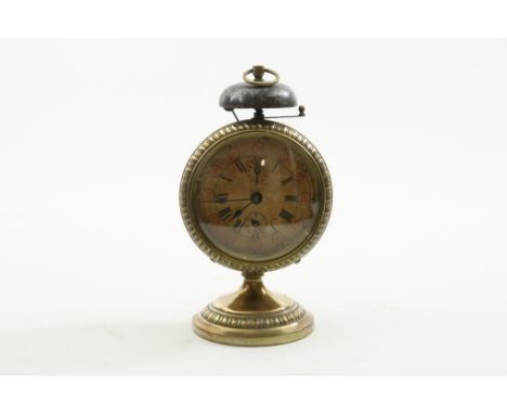 Brass travel alarm clock with bell and paper dial, ca. 1900, h.  20,5 cm.Messing reiswekker met bel en papieren wijzerplaat, 