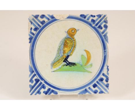 Polychrome Delft tile, 17th. century with a bird in a circle and  at the corners Wanli decor. Thickness: 1 cm.Polychrome Delf
