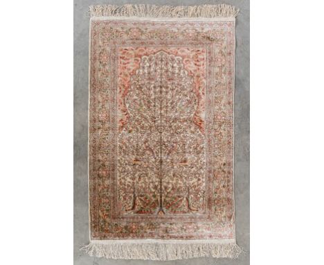 An Oriental hand-made carpet with 'Tree of Life' silk.Dimensions: (L:82 x W:133 cm)