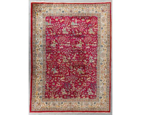 A large Oriental hand made carpet, hunting scènes, Tabriz.Dimensions: (L:329 x W:252 cm)
