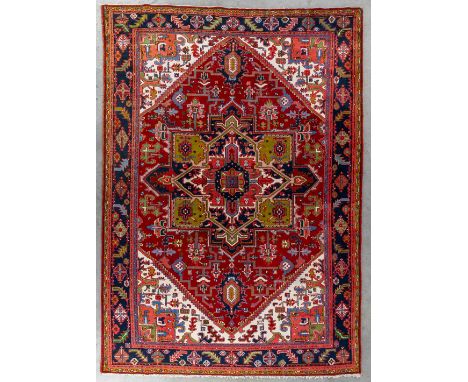 An Oriental hand-made carpet, Heriz.Dimensions: (L:350 x W:252 cm)