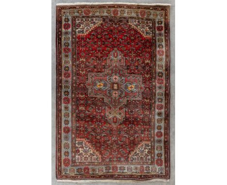 An Oriental hand-made carpet, Hamadan.Dimensions: (L:197 x W:127 cm)
