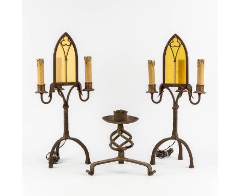 A pair of wrought iron table lamps in a Gothic Revival style. Added a candlestick.&nbsp;Dimensions: (H:63 cm)