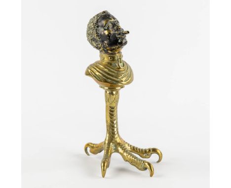 An antique Cigarette or Cigar lighter, polished and patinated&nbsp;bronze in the shape of a Blackamoor and standing on a chic
