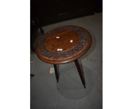 A 19th Century mahogany occasional table in the gypsy style having carved circular top on bobbin turned splay legs, diameter 
