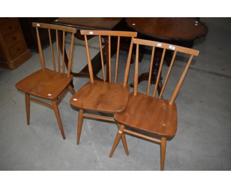 A set of three Ercol kicthen chairs having spindle backs