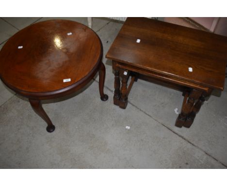 A 1930's circular walnut occasional table, sold along with a nest of two oak occasional tables