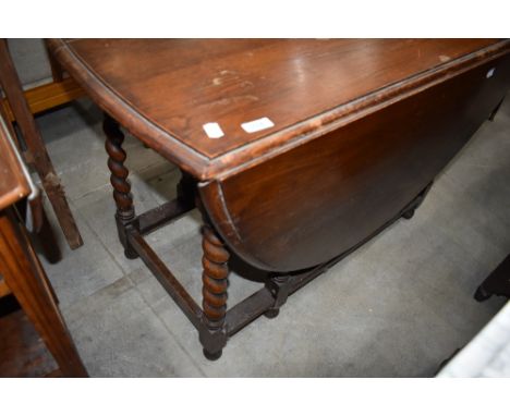 An early to mid 20th Century oak twist gate leg dining table