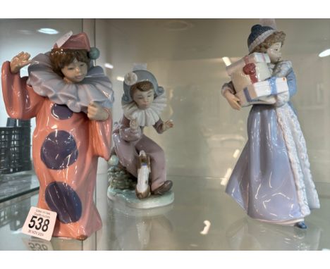 Three vintage Nao figurines one ' 1985 girl with presents', ' Listen to the Harlequinn with dog' and 1986 Nao clown'