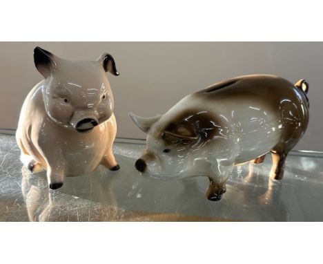 Two porcelain pig money banks one Goebel
