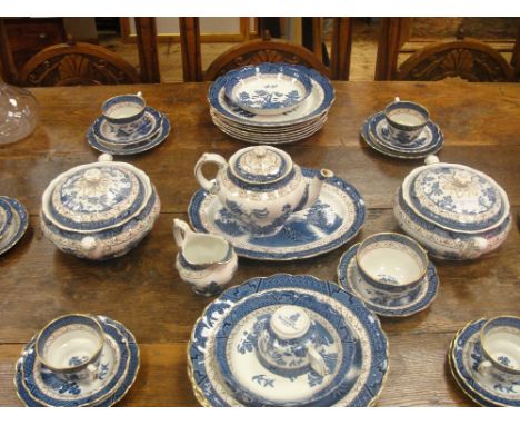 A Booths 'Willow Pattern' tea and dinner service, comprising six cups and saucers, six dinner plates and pudding plates, one 