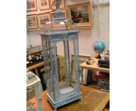 A large metal and glass garden lantern