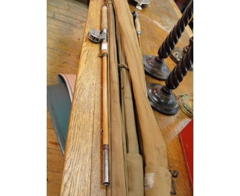 A quantity of split cane fishing rods; together with a brass two inch vintage reel