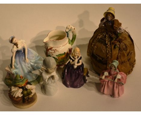 A mixed lot of porcelain figures, to include a Victorian china tea cosy figure, 23cm high, three Royal Doulton statuette's Gi