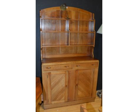 A retro walnut dresser, with open shelving and affixed angle poise lamp to top section above two small drawers and two panell