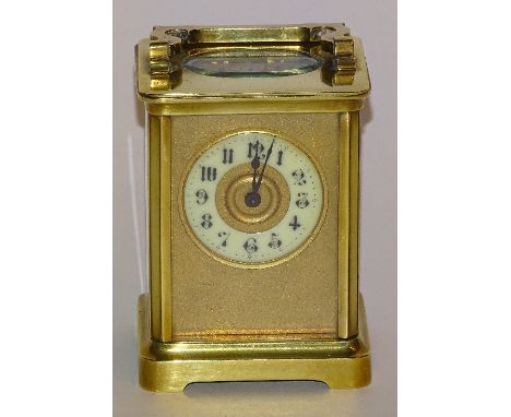 A brass carriage clock, the enamel dial within gilded ground, with carry handle, 11cm high