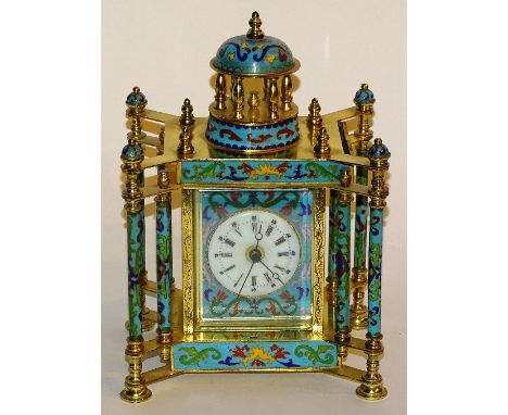 A modern champleve style mantel clock, with portrait panels to the side and battery movement, 27cm high