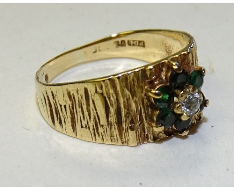 A 9ct gold emerald and diamond flowerhead ring, stamped 375, ring size R, 3.1g