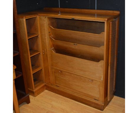 A retro walnut utility corner unit, with record shelving above a fall front flanked with open shelving, door to the side encl