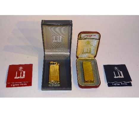 Two vintage Dunhill gold coloured lighters, one example patented, with books of lighter flints, in fitted boxes (2)