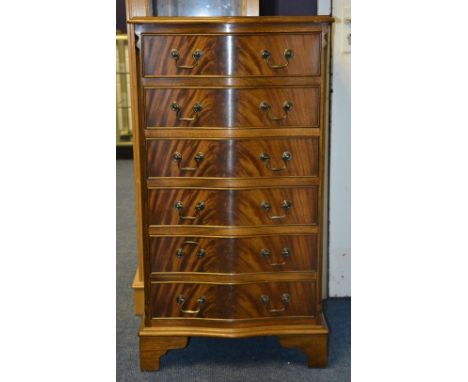 A reproduction mahogany serpentine chest of drawers, with six drawers raised on bracket supports, 99cm high x 54cm wide x 44c
