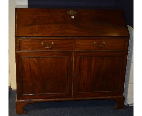 A 19th century mahogany writing bureau, with fall front enclosing fitted drawers and pigeon holes above two small drawers and