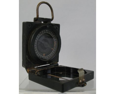 A World War II magnetic marching compass Mark I, in square bakelite hinged case marked T G Co Ltd serial no.B281359, 6.5cm sq