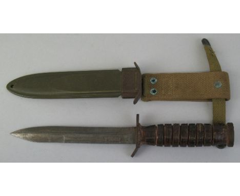 A World War II US M3-Utica fighting knife, with 17cm steel blade and turned wooden handle, in canvas mounted green metal scab