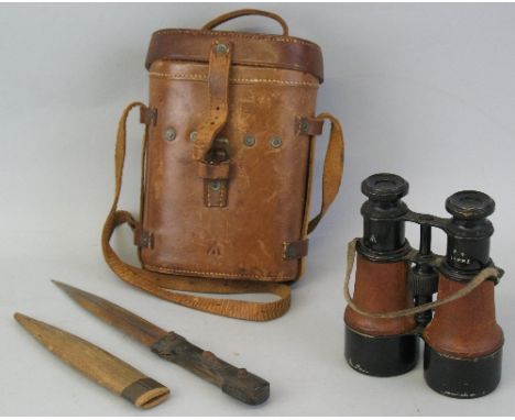 A pair of World War I British Officers binoculars, the leather covered and lacquered brass body inscribed with a broad arrow 