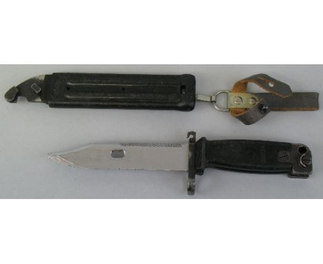 An East German AK47 knife bayonet, with 14.5cm steel saw back blade and original scabbard with corresponding numbers, 32.5cm 