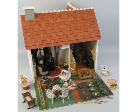 A scratch built wooden dolls house, as a double fronted country cottage with simulated stucco front, boarded sides and pitche